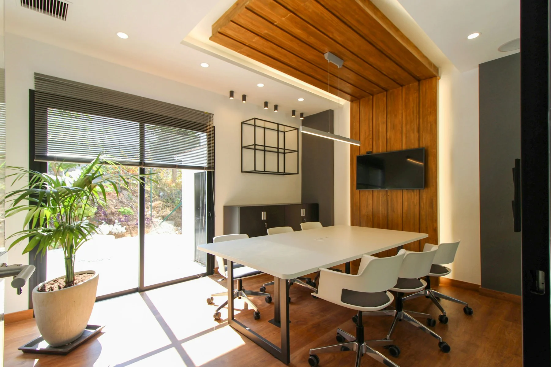 Office meeting room behind large interior glass